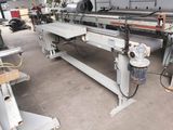 a machine that is working on a piece of wood