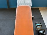 an orange bench in the middle of a gym room