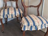 two chairs sitting next to each other in a room