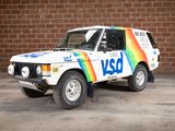 a white van with a rainbow painted on it parked in front of a brick wall