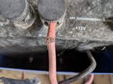 a close up of a car ' s engine with wires attached to it