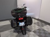 a motorcycle that is parked in a room with a checkered floor