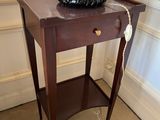 a table with a lamp on top of it in a room