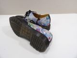 dr martenson shoes with floral print on them on a white surface