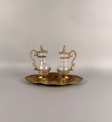pair of silver and gold plated sugar and pepper shakers on a tray