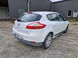the rear end of a white car parked in front of a building