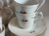 a lot of cups and saucers sitting on a table