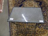 a table with a glass top sitting on a rug