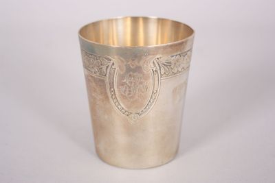 a silver cup sitting on a white surface