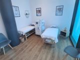 a picture of a hospital room with two beds and chairs