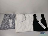 three t - shirts are sitting on a table next to each other