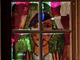 a stained glass window with a picture of a woman and a horse