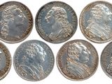 six different types of silver coins are shown on a white background