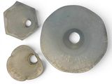 three pieces of metal that are on a white surface