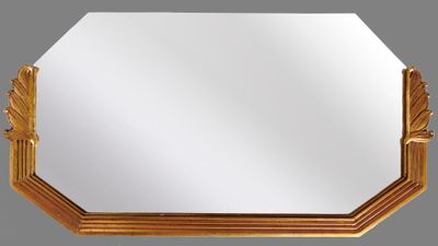 un miroir octogonal avec un cadre doré sur fond gris