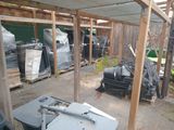 a lot of trash in the yard under the awning
