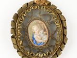 an antique picture of a woman holding a baby in a gold frame