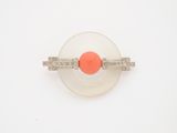an orange and white ring with diamonds on a white surface