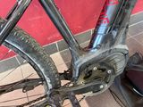 a close up of a bicycle that is chained to a wall