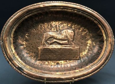a bronze bowl with a lion on it