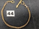 un bracelet en chaîne d'or sur lequel figure le chiffre 44