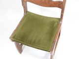 a wooden chair with a green seat pad on it