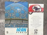 a small red car parked next to a postcard with a picture of a dome