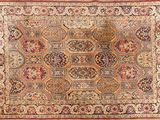 an antique persian rug with a medallion design