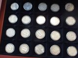 a display case with a lot of silver coins in it