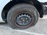 a flat tire on the side of a white truck