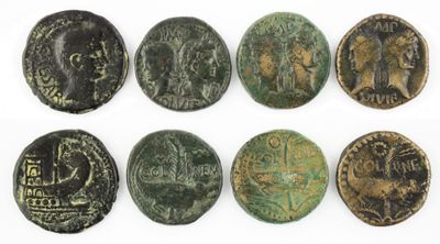a group of six ancient roman coins on a white surface