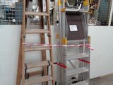 a ladder that is leaning against a wall next to a ladder