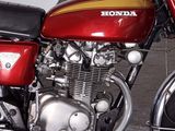 a red motorcycle parked on the side of the street