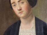 portrait of a woman in a blue jacket and white dress