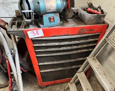a red tool box with tools on it next to a pile of other tools