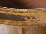 a close up of a pot with a brown substance on it