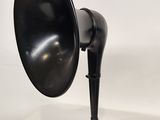 an image of a black and silver lamp on a white surface
