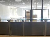 a glass counter in the middle of a large room