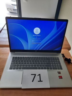 an open laptop computer sitting on top of a wooden table