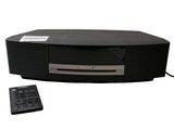 an image of a black stereo system with a remote on top of it