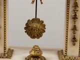 a gold clock with a lion head hanging from it ' s side