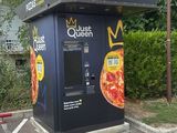 a pizza kiosk in the middle of a parking lot