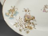 a plate with flowers on it sitting on a table