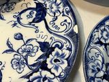two plates with blue and white designs on them