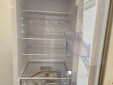 an open refrigerator that is sitting in a room