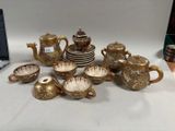 many different types of teapots and cups on the table