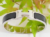 an image of a bracelet with a black and white design on it
