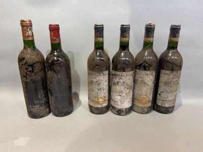 several bottles of wine are lined up on a table