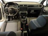 the interior of a small car with a steering wheel and dashboard