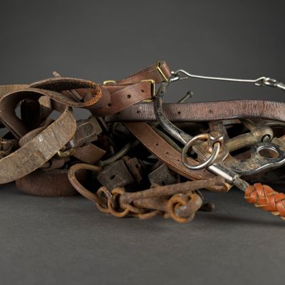 a pile of leather and metal items sitting on a table